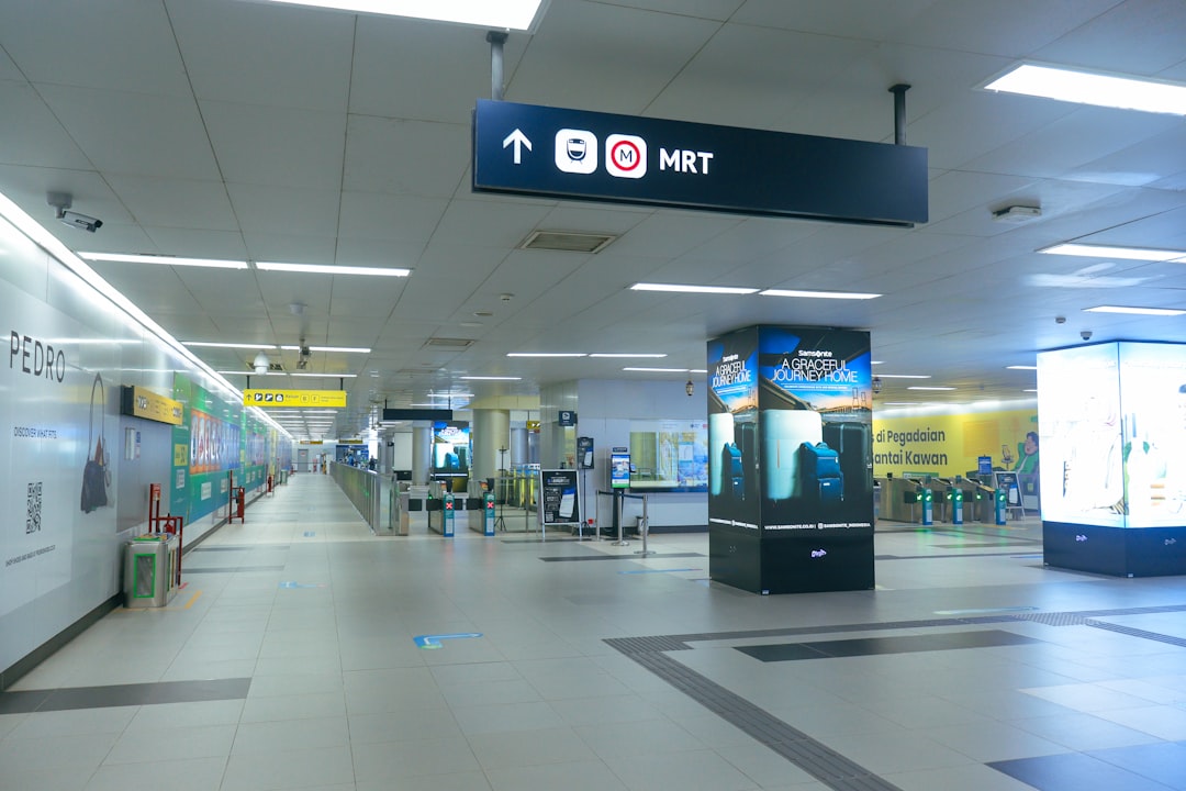 Empty mrt station with signs and advertisements.